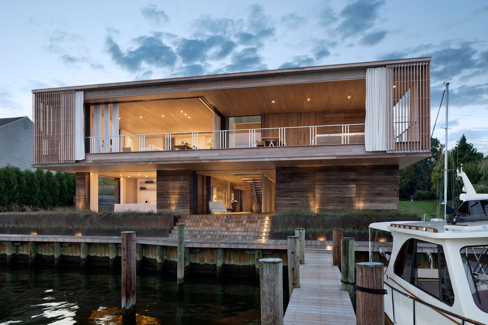 Bates Masi, wooden home, sailing family, Annapolis, waterfront, New York, Chesapeake Bay, Acton Cove, Maryland, capital city, Us Naval Academy, dock, boat, residence, boating, sliding glass door, curtain, indoor, outdoor, privacy, weather, living room, cantilevered decks, balcony, Acton Cove, modern, nautical aesthetic, white walls, cabinet, furniture, kitchen, couch, six PP503 chair, Hans J Wegner, swimming pool, dock, pool, bedroom, en-suite bathroom, Acton House, garage, studio, garden, Virginia-based Gregg Bleam